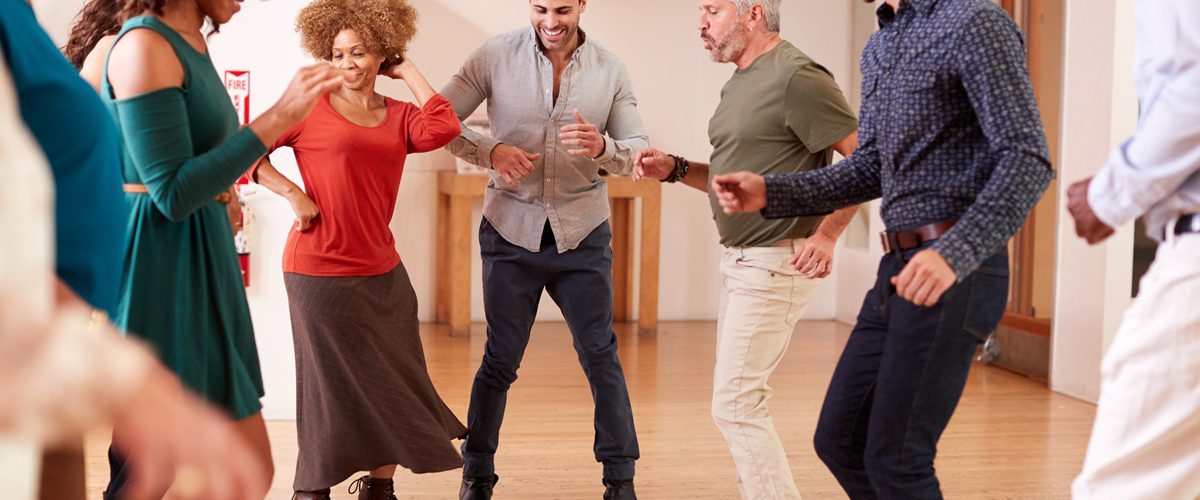 People Attending Dance Class In Community Center